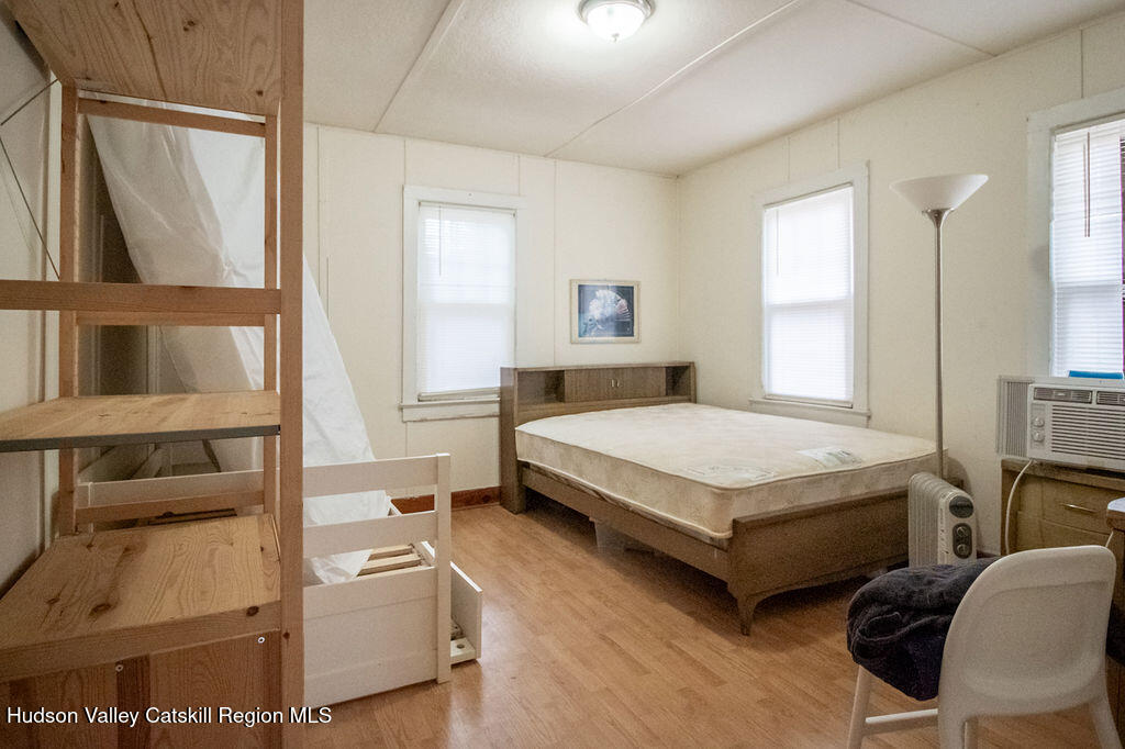 224 Camp Road Ellenville, NY 12428 - Photo 30 of 50 a bedroom with a bed wooden floor and window