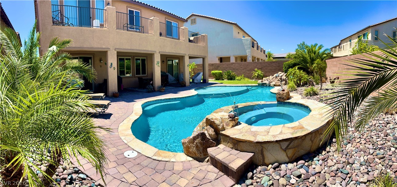 9724 University Ridge Avenue Las Vegas, NV 89149 - Photo 31 of 61 An oasis of relaxation awaits with a sparkling pool and spa, framed by tropical landscaping and a spacious patio.