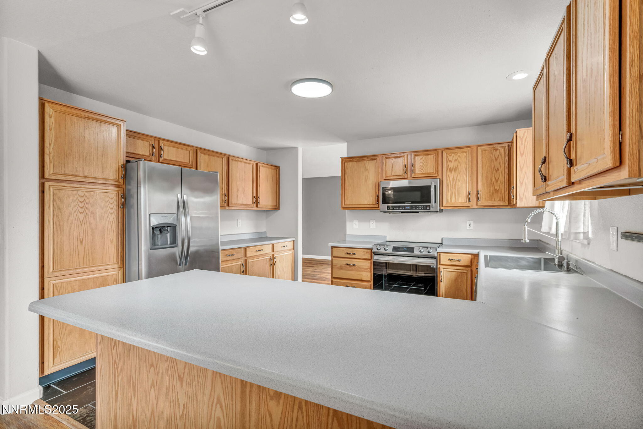 17702 Clear Springs Court Reno, NV 89508 - Photo 11 of 41 a kitchen with stainless steel appliances granite countertop a refrigerator stove microwave and sink