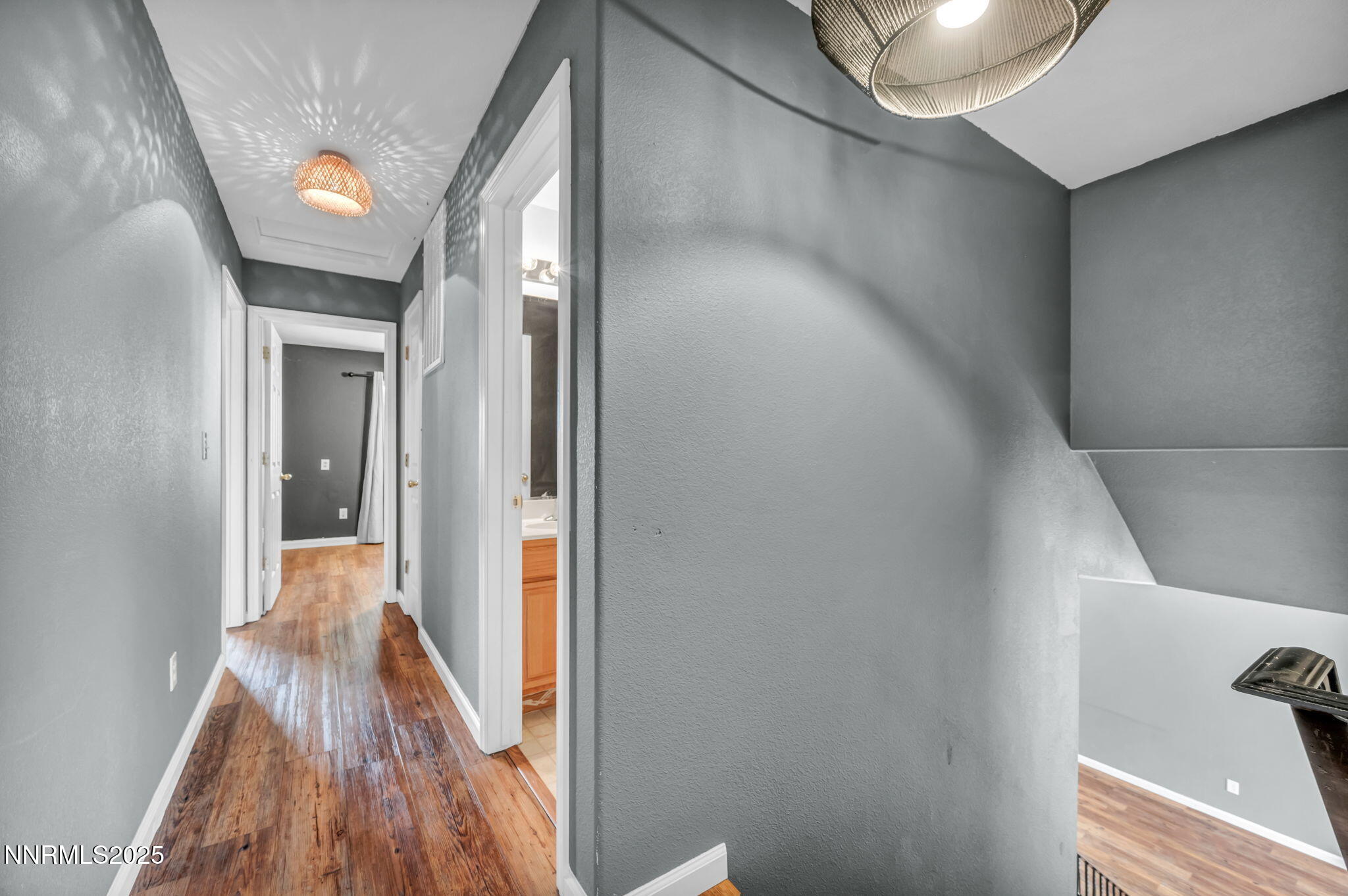 17702 Clear Springs Court Reno, NV 89508 - Photo 18 of 41 a view of a hallway with wooden floor and staircase