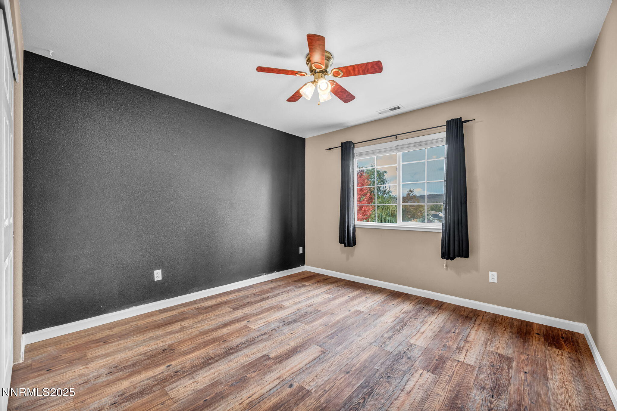 17702 Clear Springs Court Reno, NV 89508 - Photo 19 of 41 a view of an empty room with wooden floor and a window