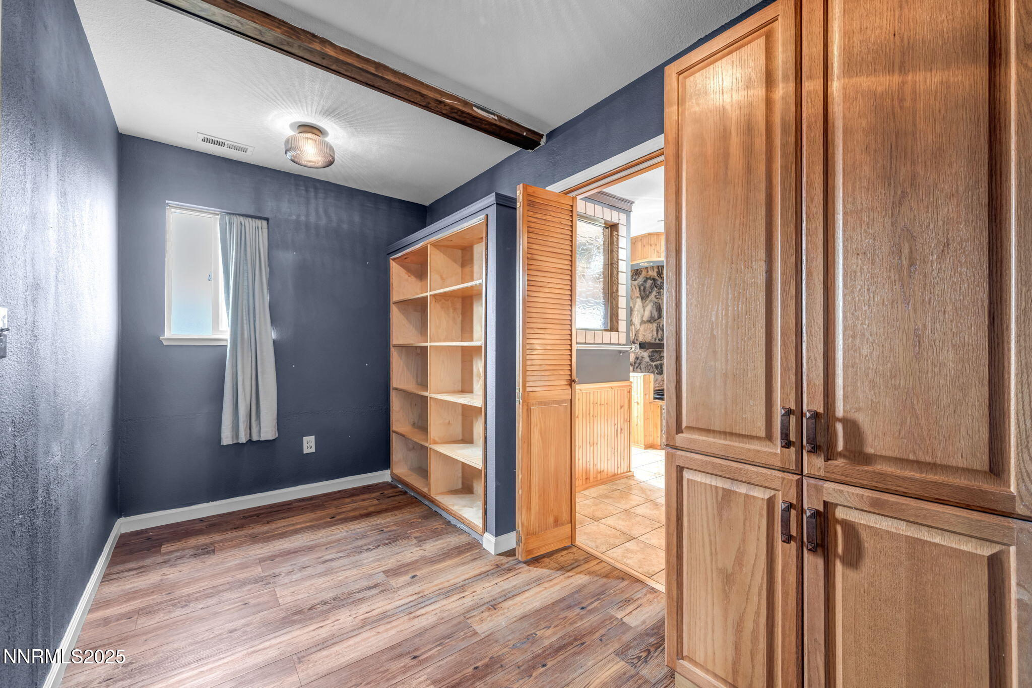 17702 Clear Springs Court Reno, NV 89508 - Photo 26 of 41 an empty room with wooden floor and windows