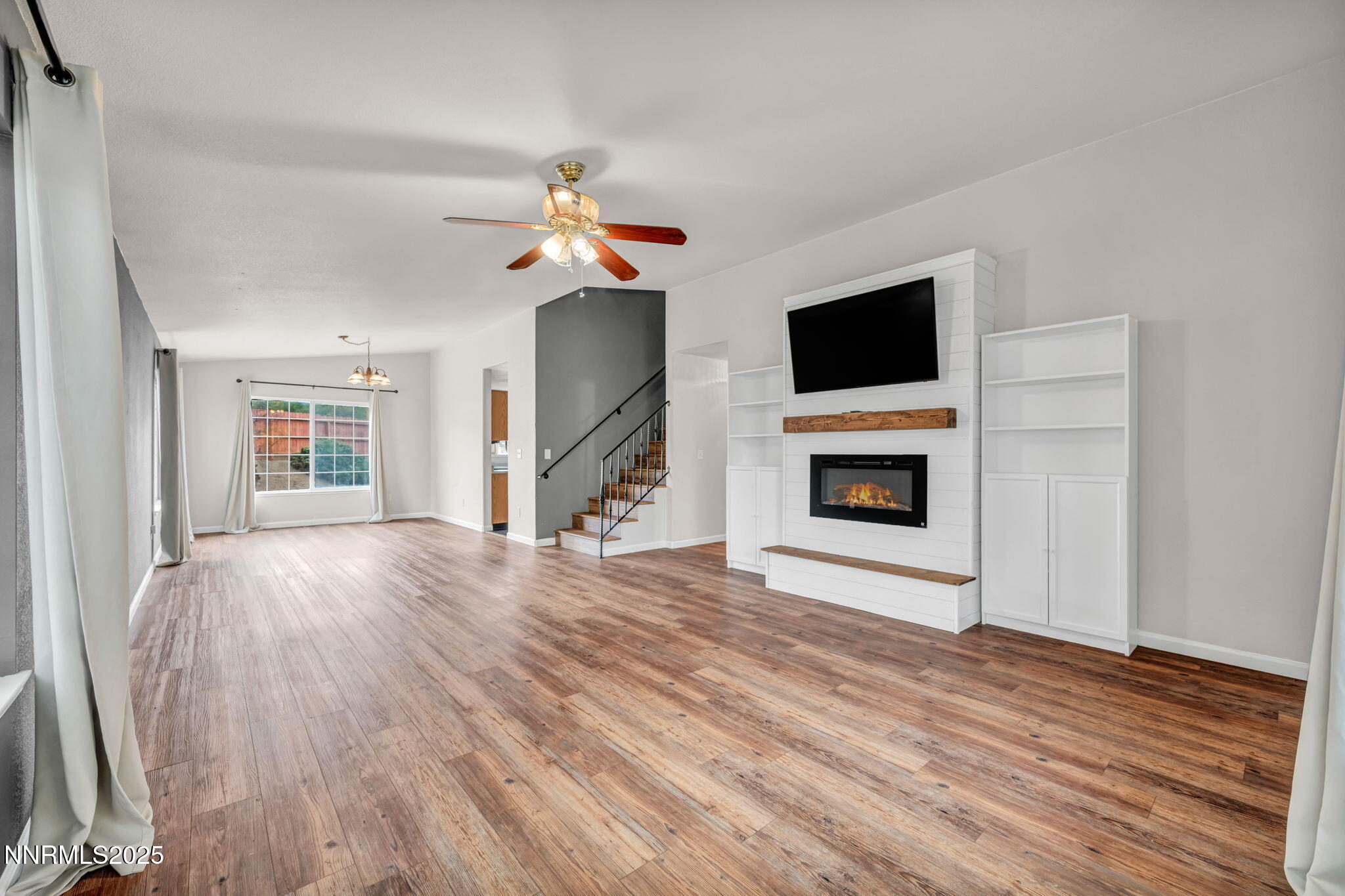17702 Clear Springs Court Reno, NV 89508 - Photo 5 of 41 a view of an empty room with wooden floor fireplace and a window