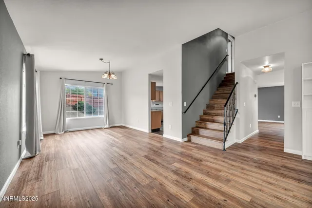 a kitchen with stainless steel appliances granite countertop a sink and dishwasher a stove top oven with wooden floor