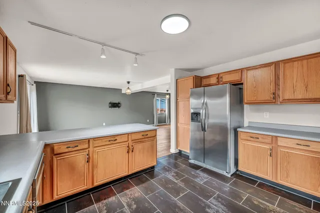 a kitchen with stainless steel appliances granite countertop a refrigerator stove microwave and sink