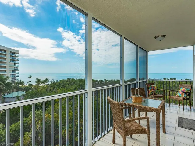 a view of a chairs and table in the balcony