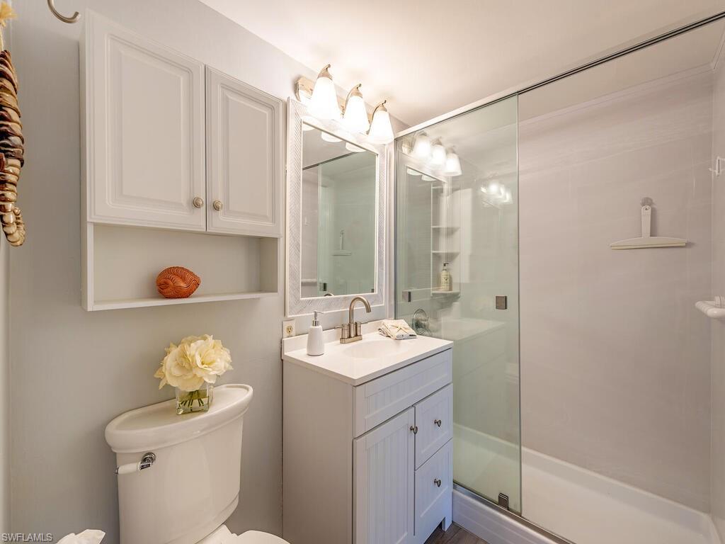 1 Bluebill Avenue, Unit 709 Naples, FL 34108 - Photo 10 of 12 a bathroom with a sink vanity granite and toilet