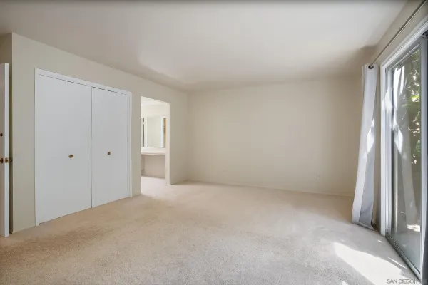 a view of an empty room and a window