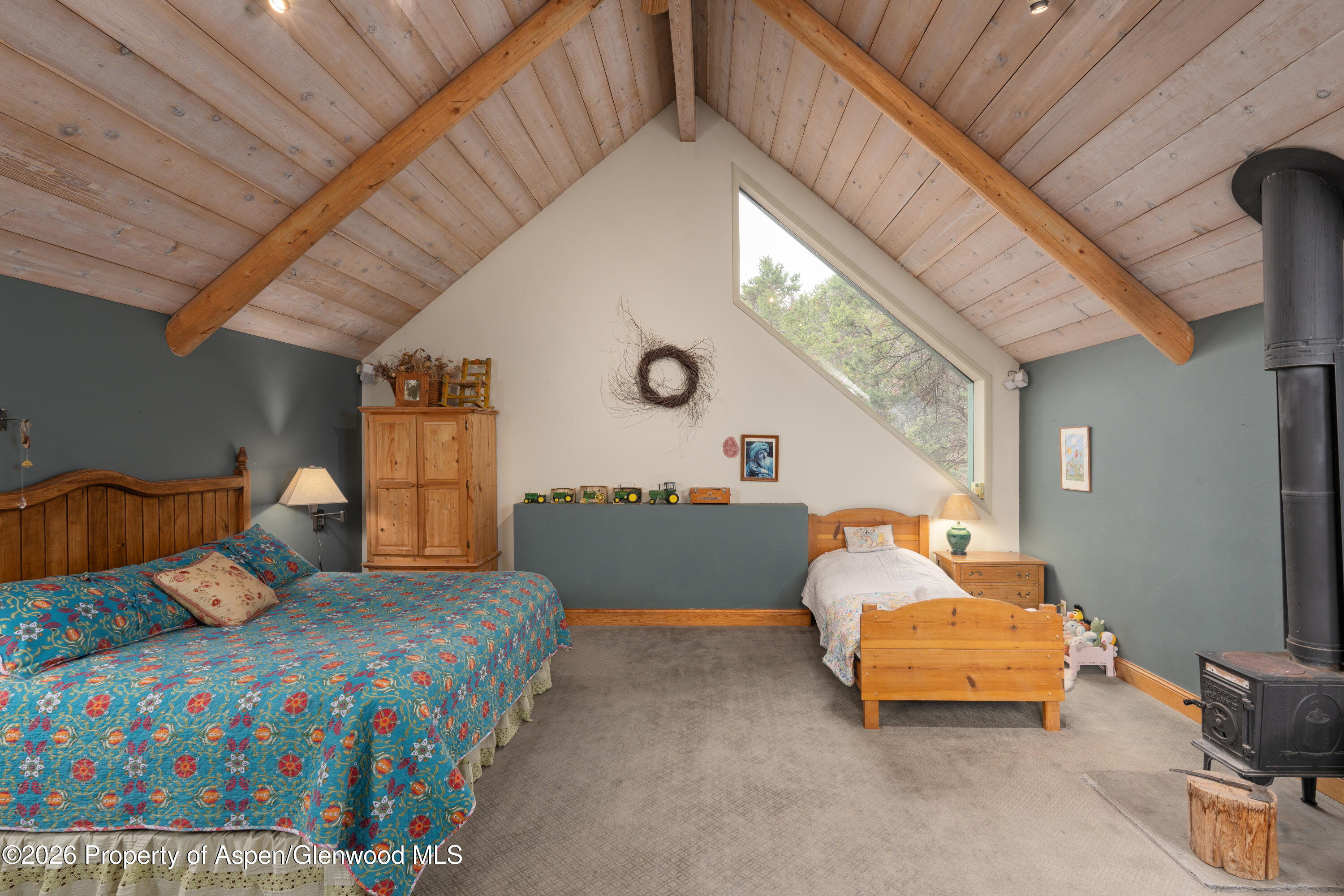 422 Sopris Creek Road Basalt, CO 81621 - Photo 17 of 50 Upstairs Bedroom with Wood Stove