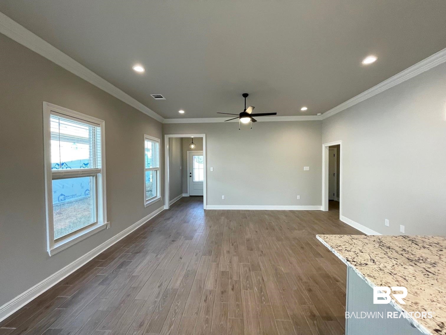 1355 Fenton Circle Foley, AL 36535 - Photo 5 of 17 Unfurnished living room featuring dark hardwood / wood-style floors, ceiling fan, and crown molding