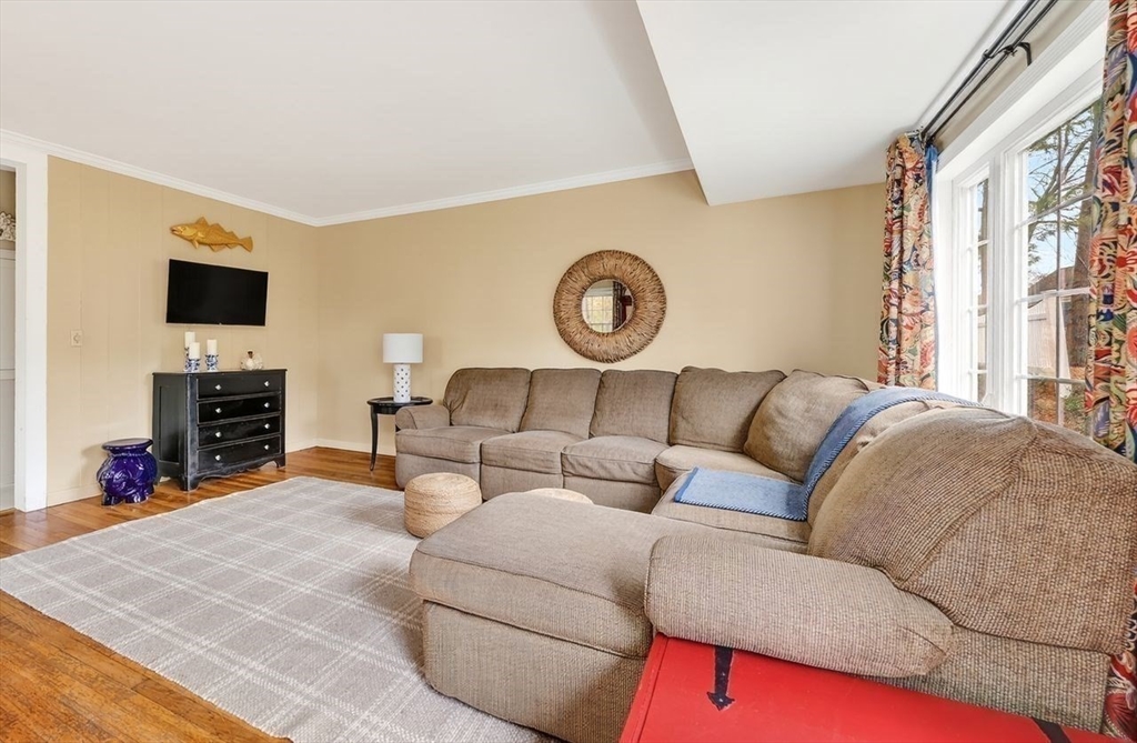 15 Leigh Road Norwell, MA 02061 - Photo 6 of 34 a living room with furniture a flat screen tv and a fireplace
