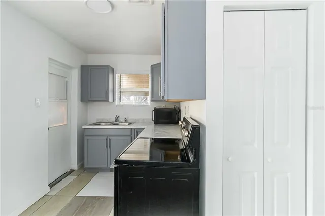a kitchen with a sink appliances and cabinets