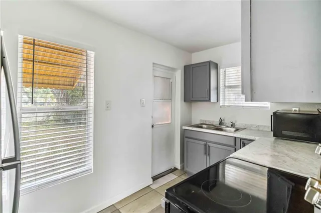 a kitchen with a sink stove and refrigerator