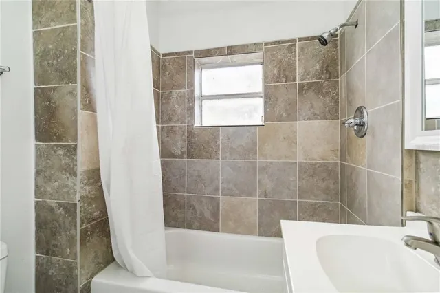 a bathroom with a bathtub and shower