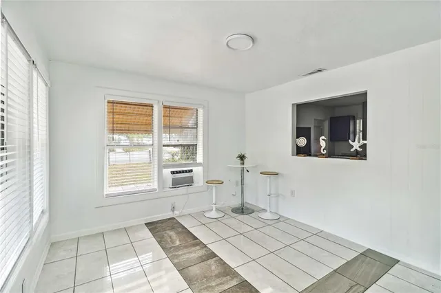 a view of a livingroom with wooden floor and a window