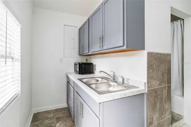 a kitchen with a sink cabinets and a window