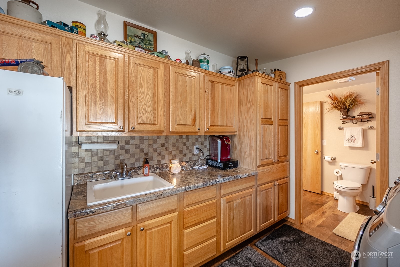 8079 Ne Road North Moses Lake, WA 98837 - Photo 23 of 26 a bathroom with a sink a toilet and shower curtain