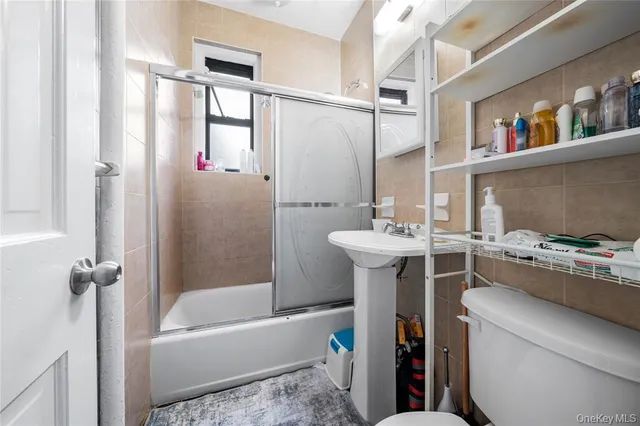 a bathroom with a bathtub a sink and a mirror