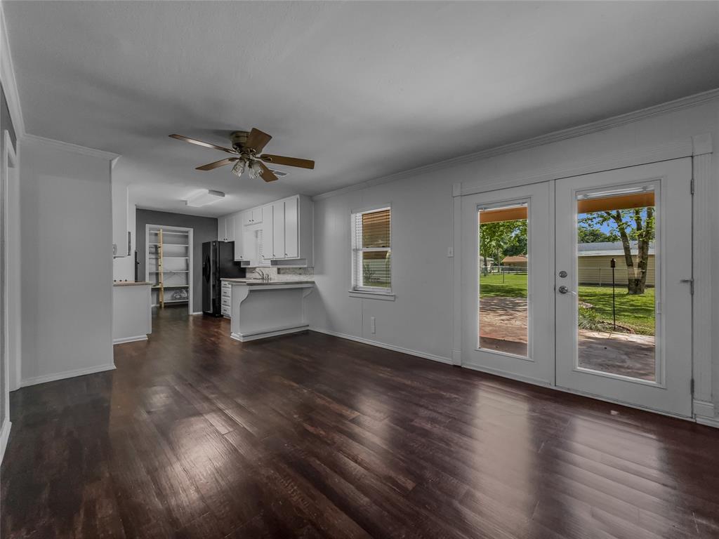 220 Cooper Drive Hurst, TX 76053 - Photo 13 of 27 a view of an empty room with a window and wooden floor