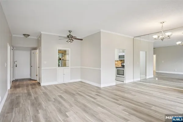 a view of a kitchen with wooden floor and a ceiling fan