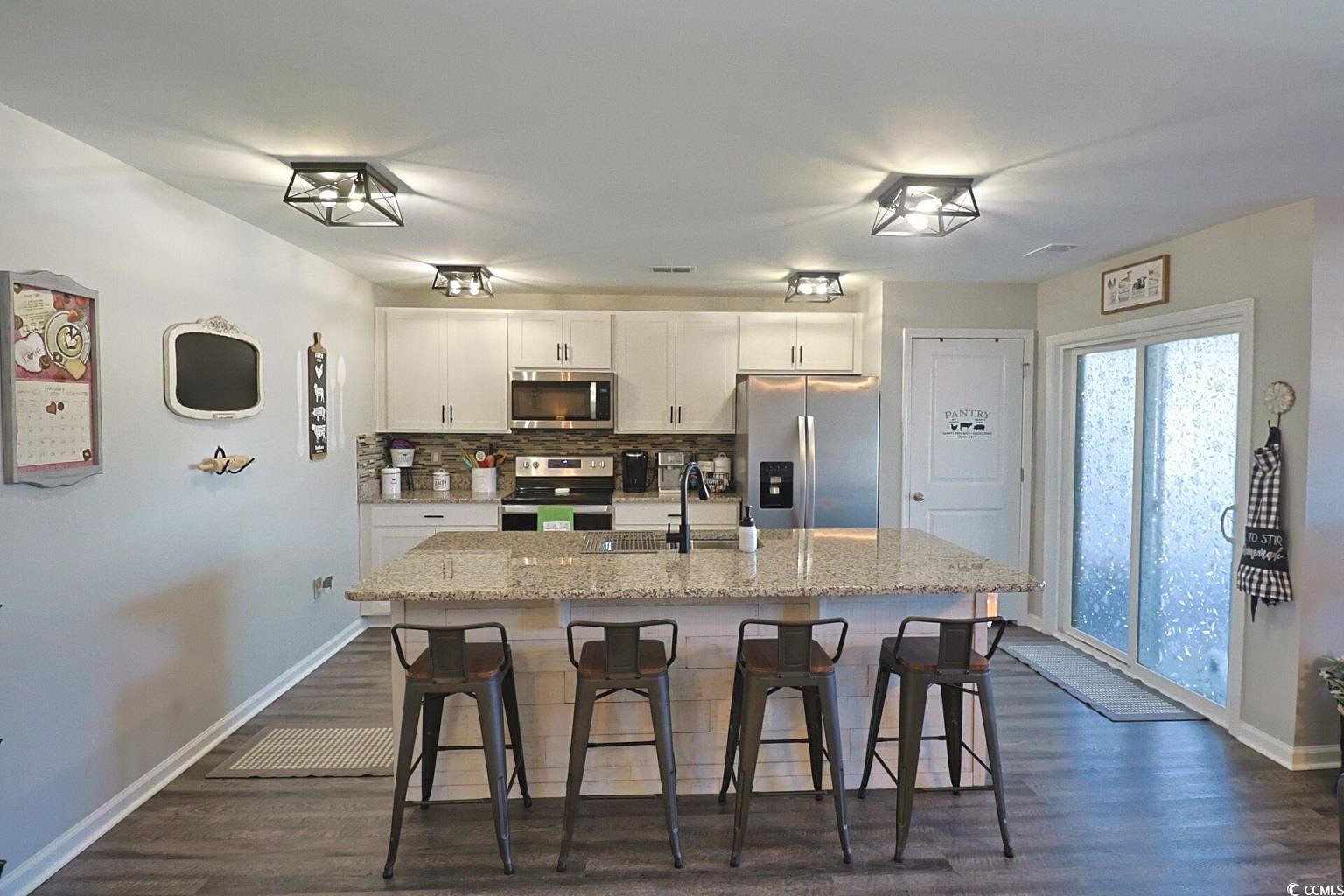 127 Clover Walk Drive Conway, SC 29526 - Photo 15 of 36 Kitchen with light stone counters, a kitchen islan