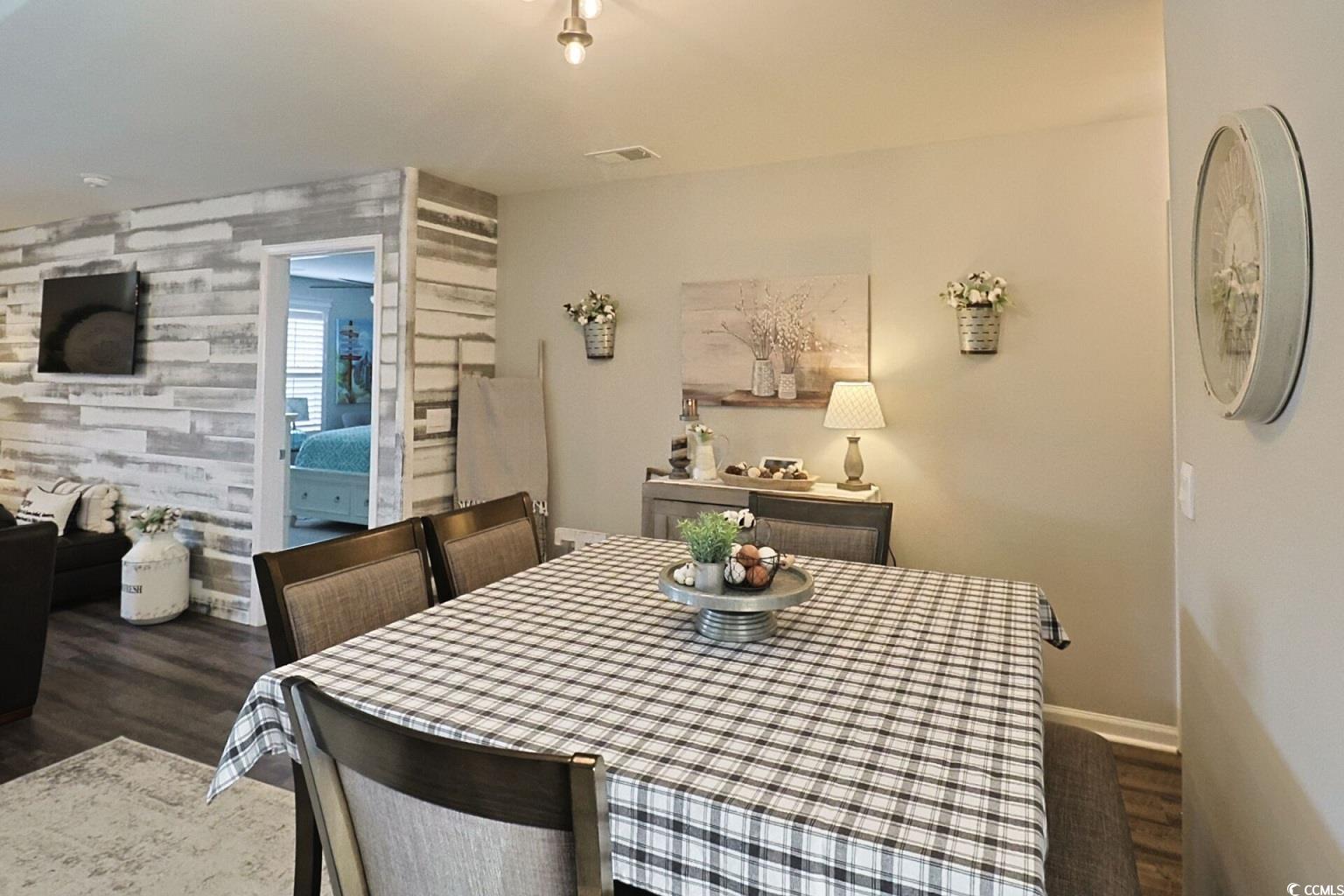 127 Clover Walk Drive Conway, SC 29526 - Photo 23 of 36 Dining area featuring an accent wall, dark wood-st