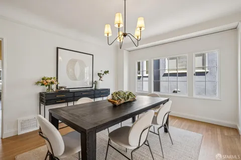 a view of a dining room with furniture wooden floor and chandelier