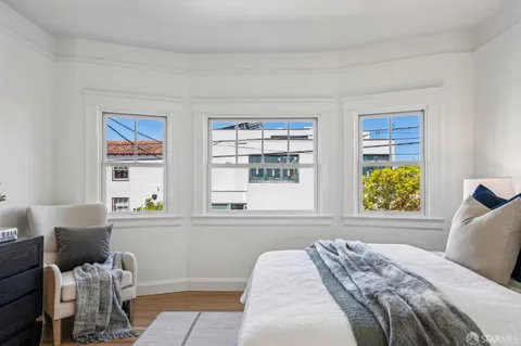 a bedroom with furniture and a potted plant