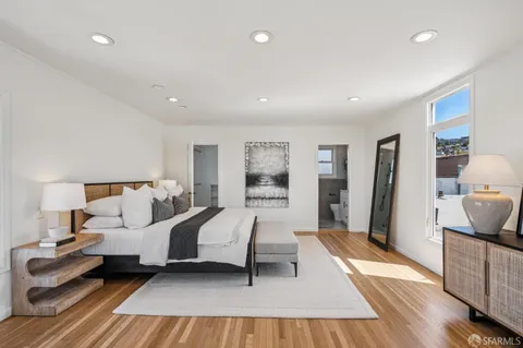 a bedroom with a bed and a view of bathroom