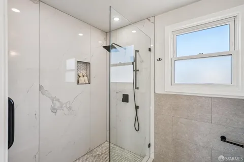 a bathroom with a shower and a glass door