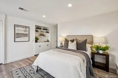 a bedroom with a bed and a chair