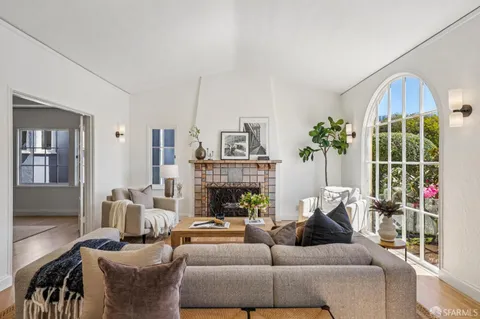 a living room with furniture fireplace and a fireplace