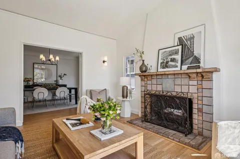 a dining room with furniture a chandelier and wooden floor