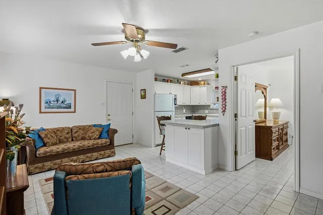 a kitchen with stainless steel appliances kitchen island granite countertop a refrigerator and a stove top oven