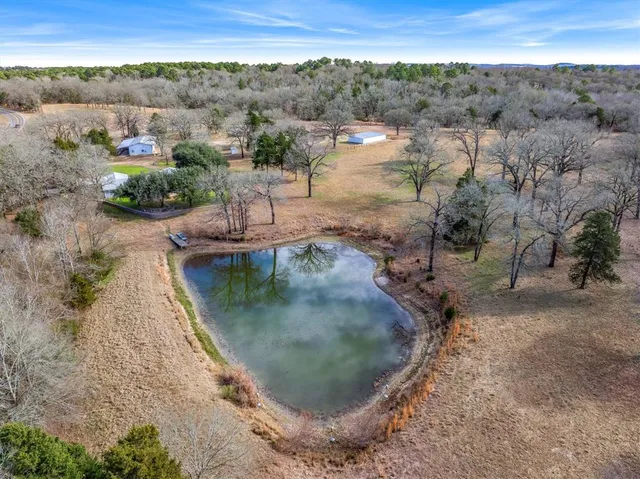an aerial view of a house with a yard