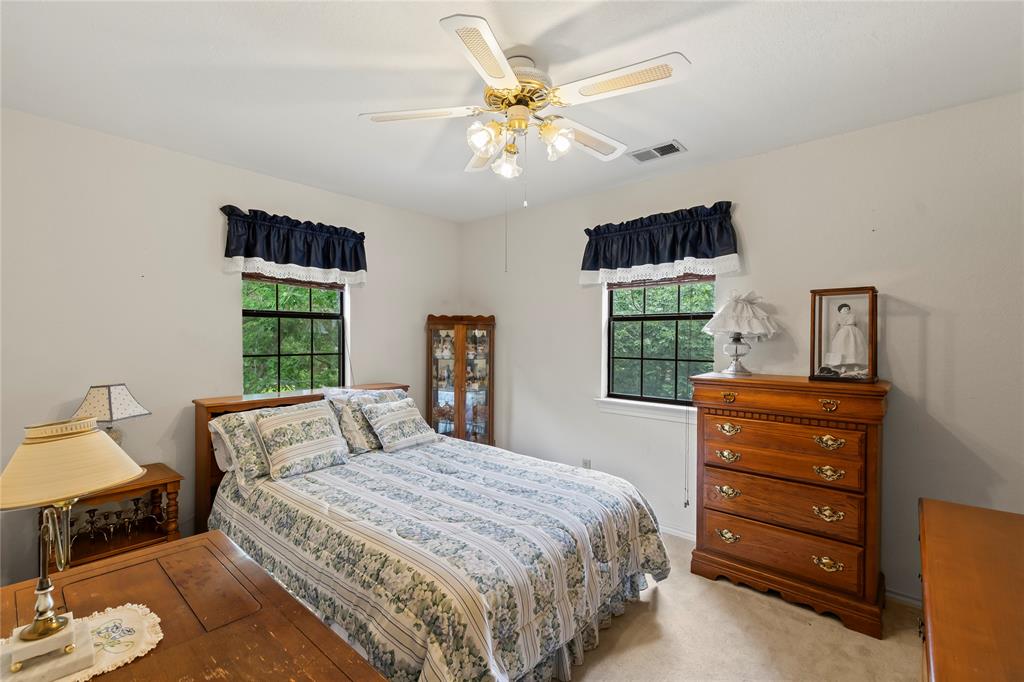 455 Stirrup Ranch Road Trinidad, TX 75163 - Photo 14 of 20 a bedroom with a bed and a dresser
