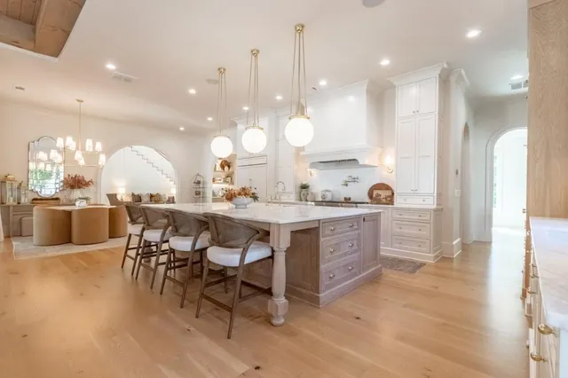 a large kitchen with a table and chairs