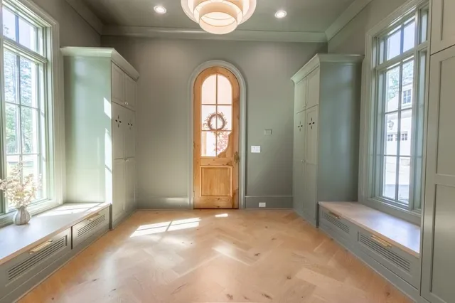 a dining room with wooden floor and a chandelier