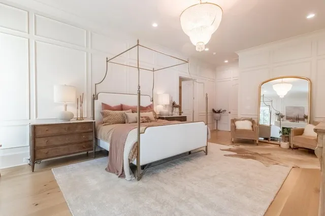 a bedroom with a bed flat screen tv and a large window