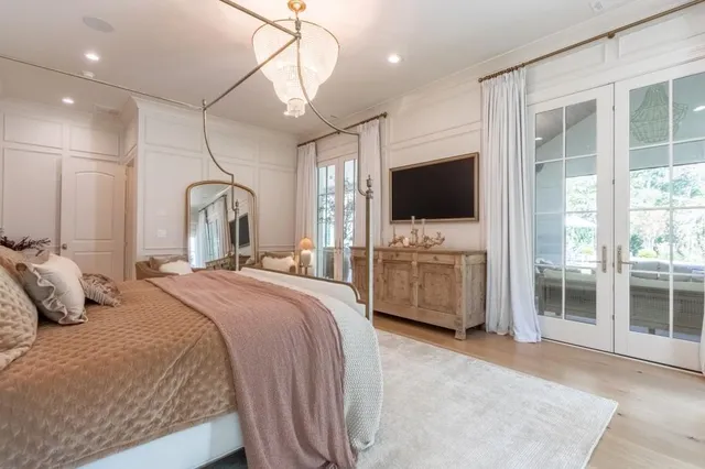 a spacious bathroom with a double vanity sink a mirror and a bathtub