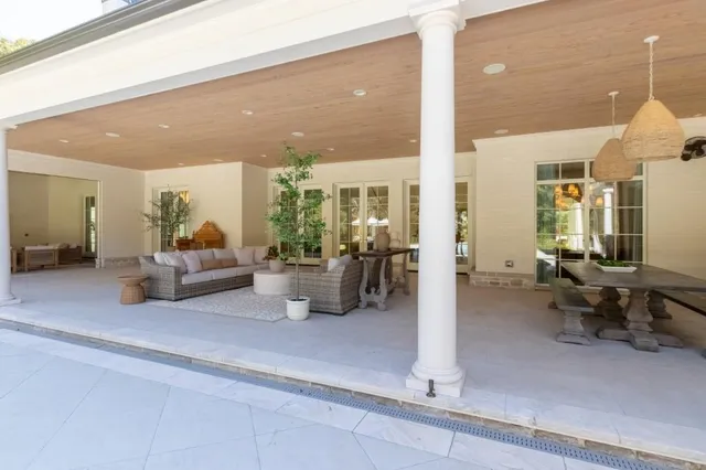 a living room with furniture a rug and a chandelier