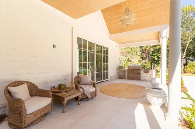 a living room with furniture flat screen tv and view
