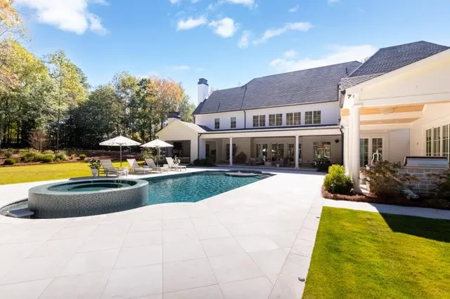 a view of a house with swimming pool and porch