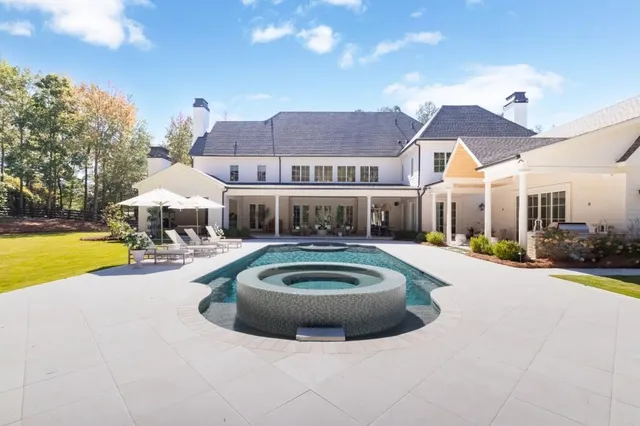 a view of house with swimming pool yard and outdoor seating
