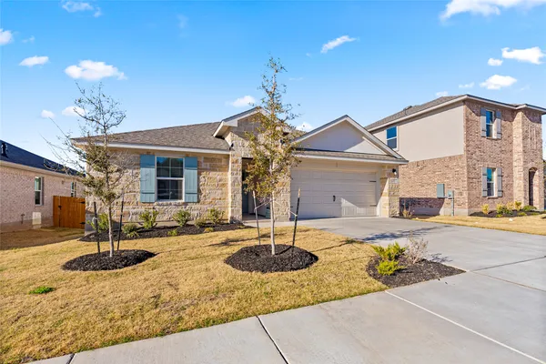 a front view of a house with a yard