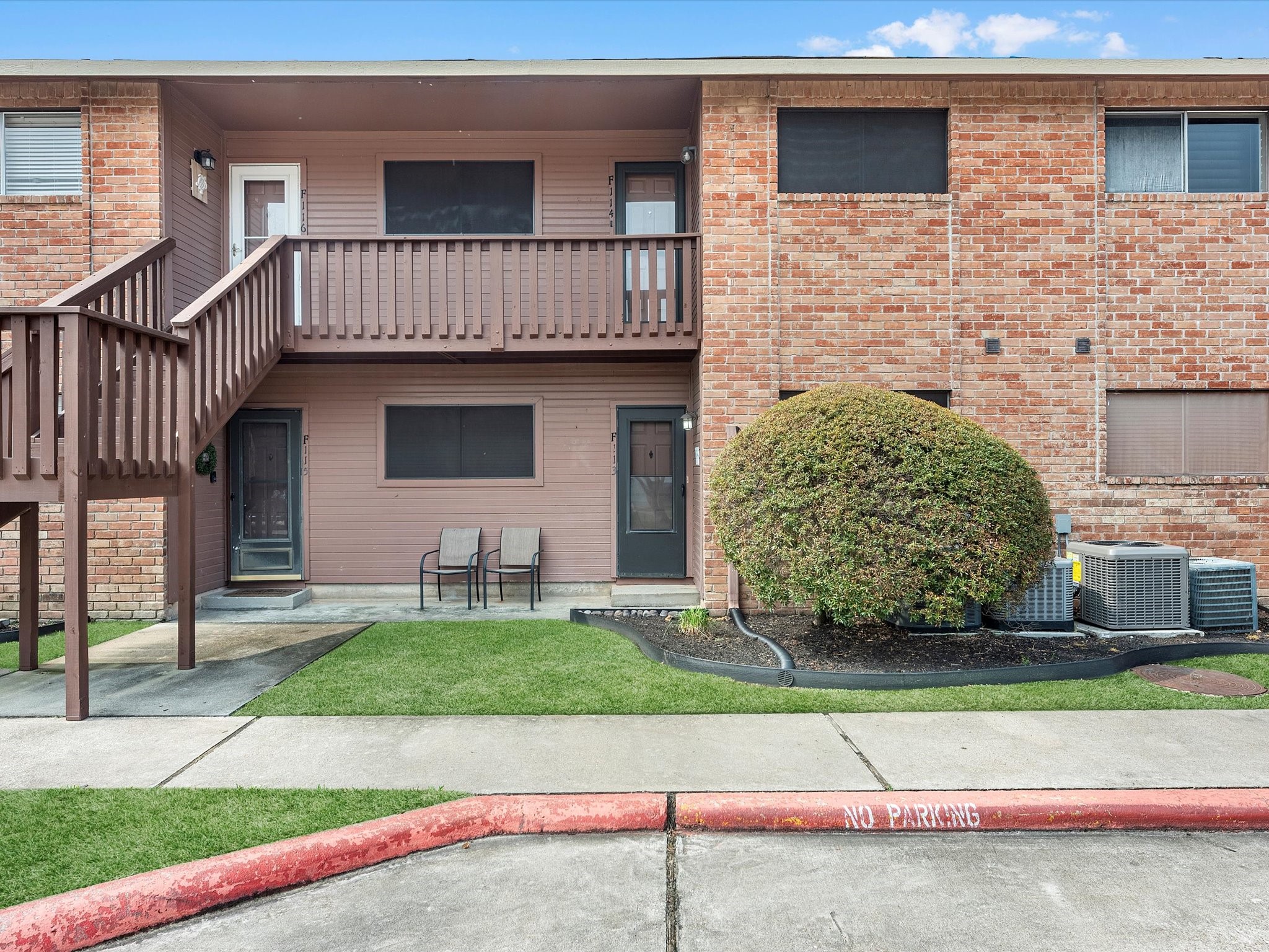 a front view of a house with a garden and plants