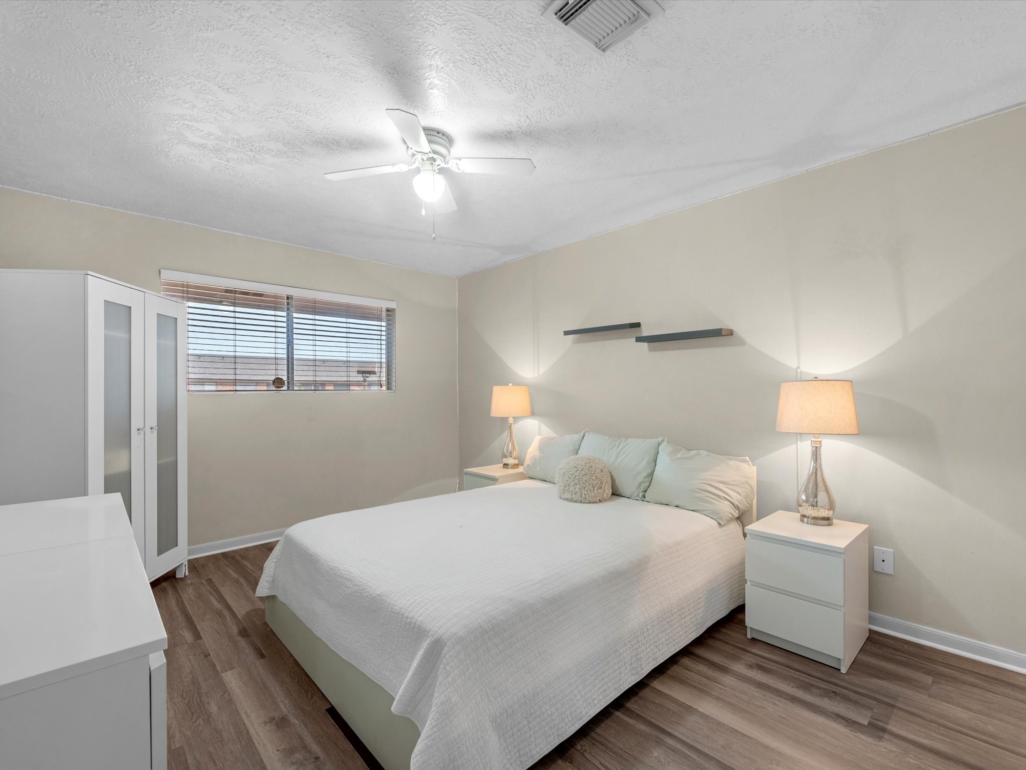 801 River Road, Unit 114F Montgomery, TX 77356 - Photo 12 of 25 a bedroom with a bed and a night stand