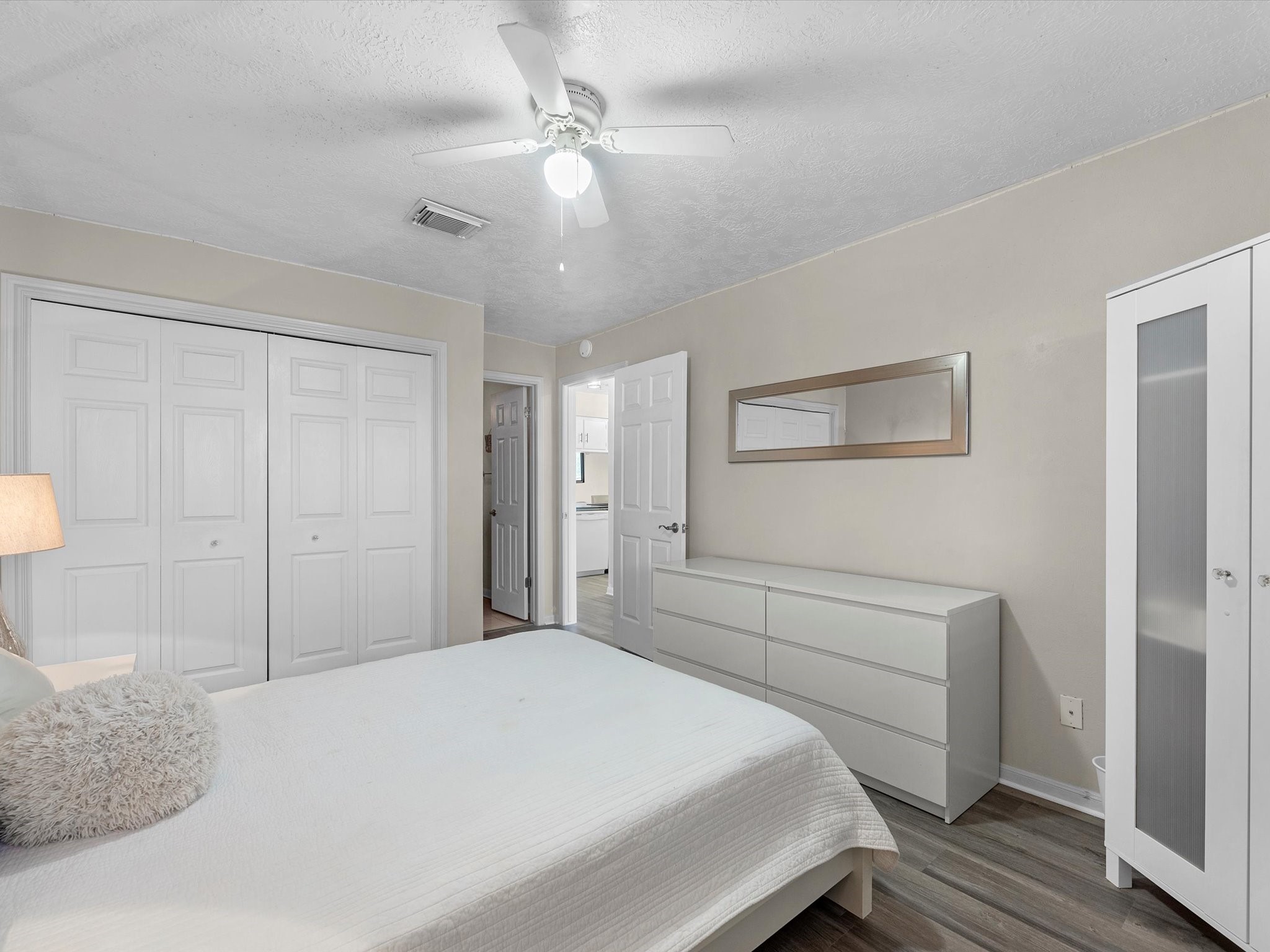 801 River Road, Unit 114F Montgomery, TX 77356 - Photo 13 of 25 a bedroom with a bed and a chandelier