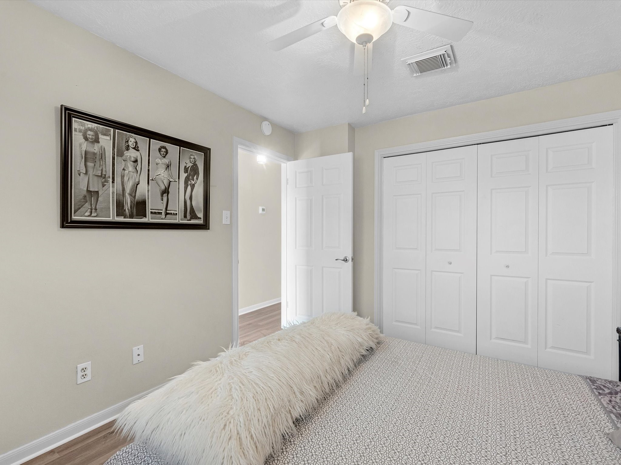 801 River Road, Unit 114F Montgomery, TX 77356 - Photo 16 of 25 a bedroom with a bed and a chandelier