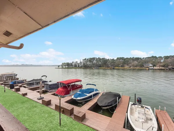 a terrace with outdoor seating and lake view